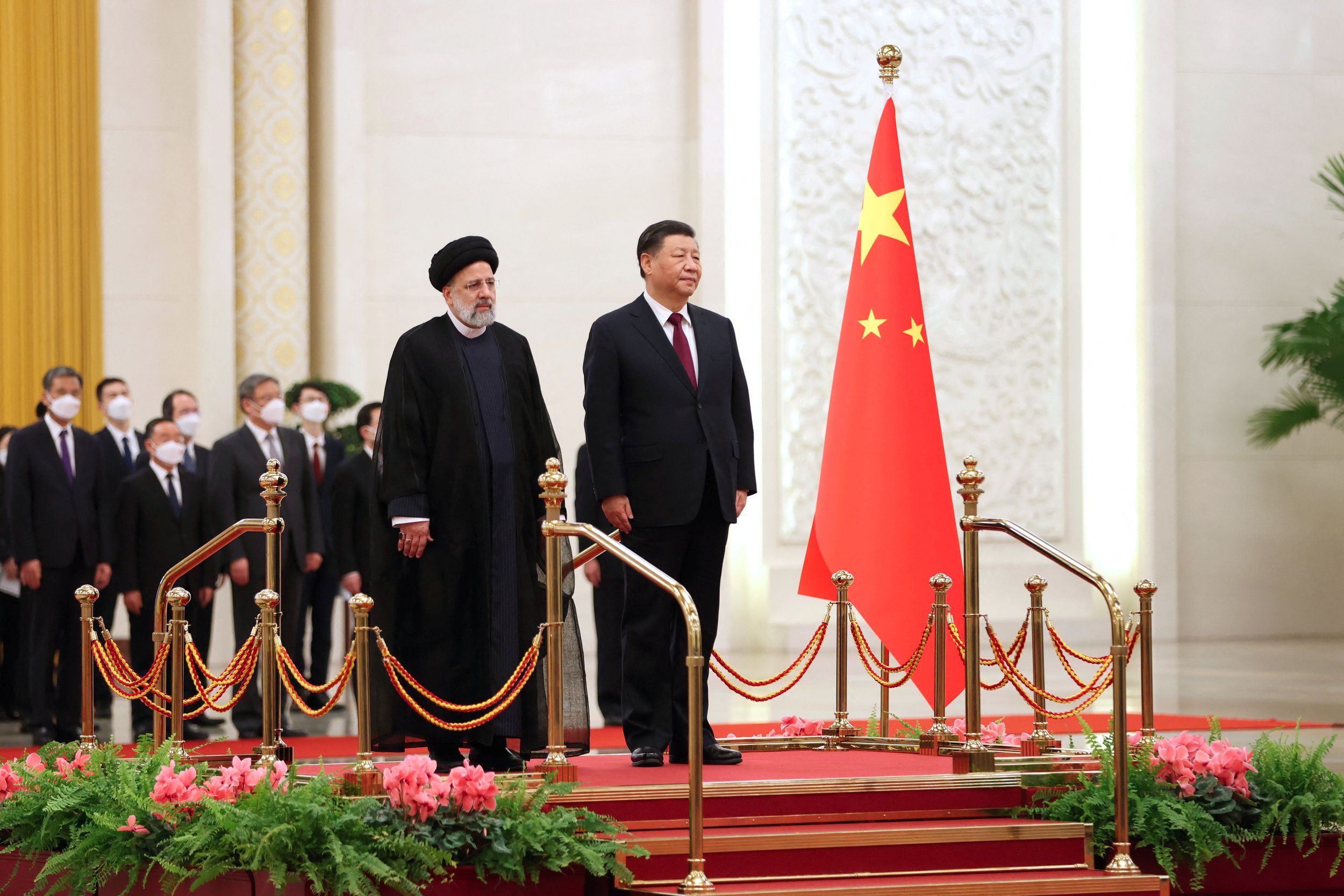 Iranian President Ebrahim Raisi stands next to Chinese President Xi Jinping during a welcoming ceremony in Beijing, China, February 14, 2023. 