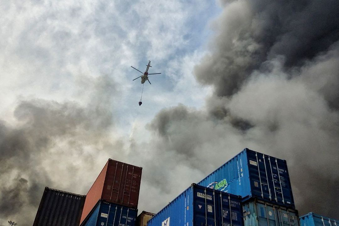 A helicopter extinguishes fire following an explosion at the Rajaei port in Bandar Abbas, Iran, April 27, 2025.