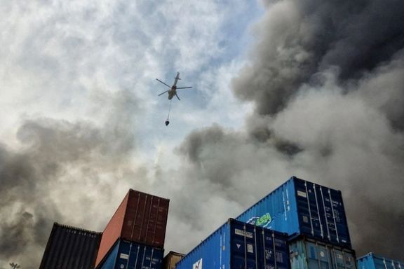 A helicopter extinguishes fire following an explosion at the Rajaei port in Bandar Abbas, Iran, April 27, 2025.