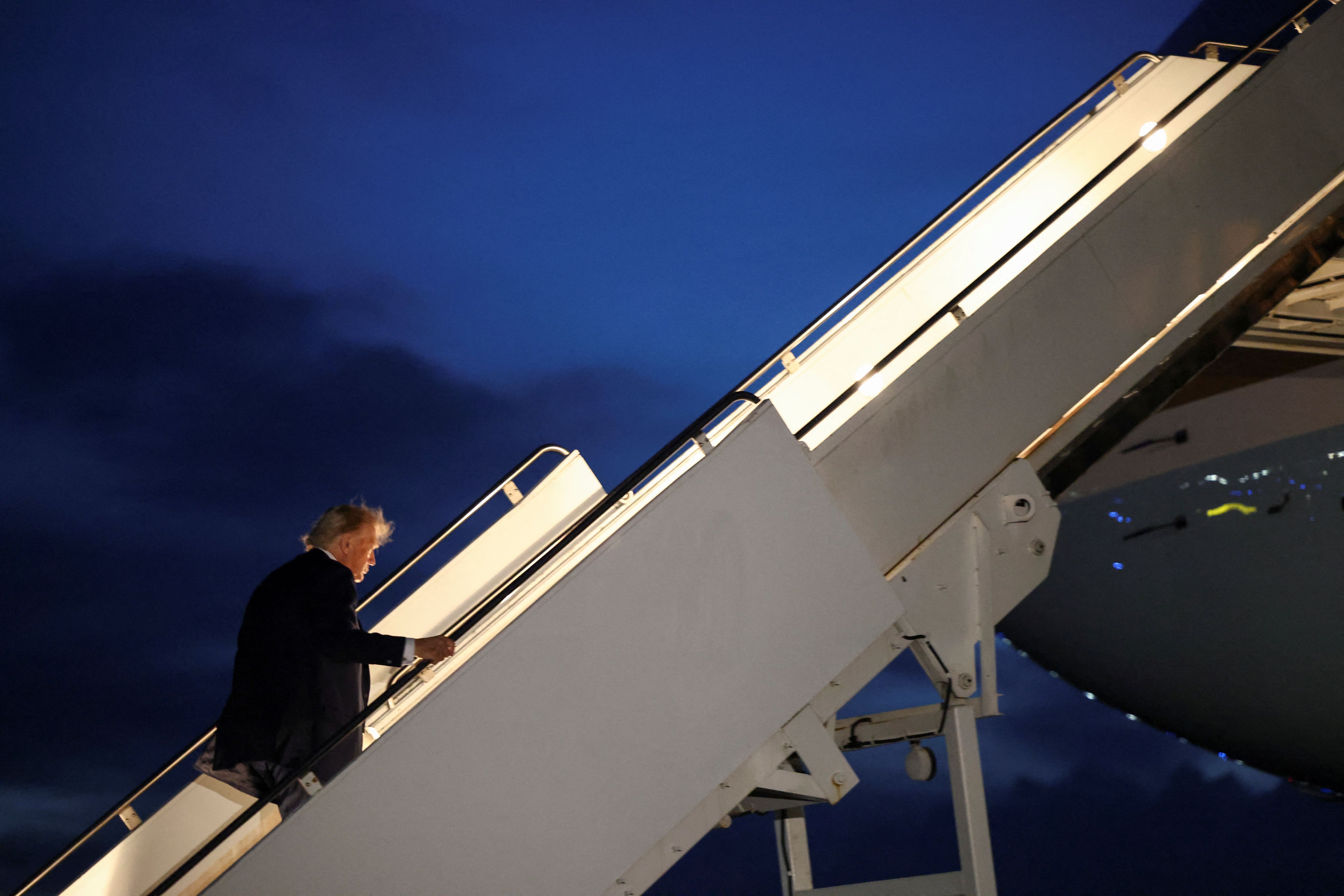 US President Donald Trump boards Air Force One as he departs early from the G7 Leaders' Summit in the Rocky Mountain resort town of Kananaskis to return to Washington, at Calgary International Airport in Calgary, Alberta, Canada, June 16, 2025. 