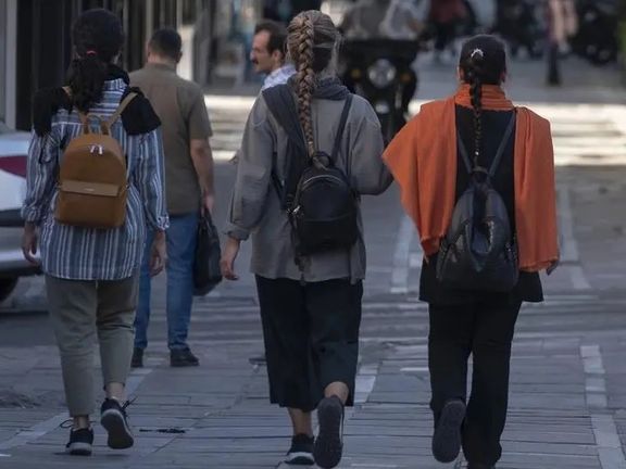 Young women walk in Tehran street in this undated file photo
