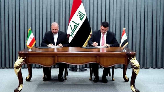 Iraqi Prime Minister Mohammed Shia Al-sudani (right) and Iran’s ambassador Mohammad-Kazem Ale-Sadegh during the signing ceremony of the barter deal on July 11, 2023