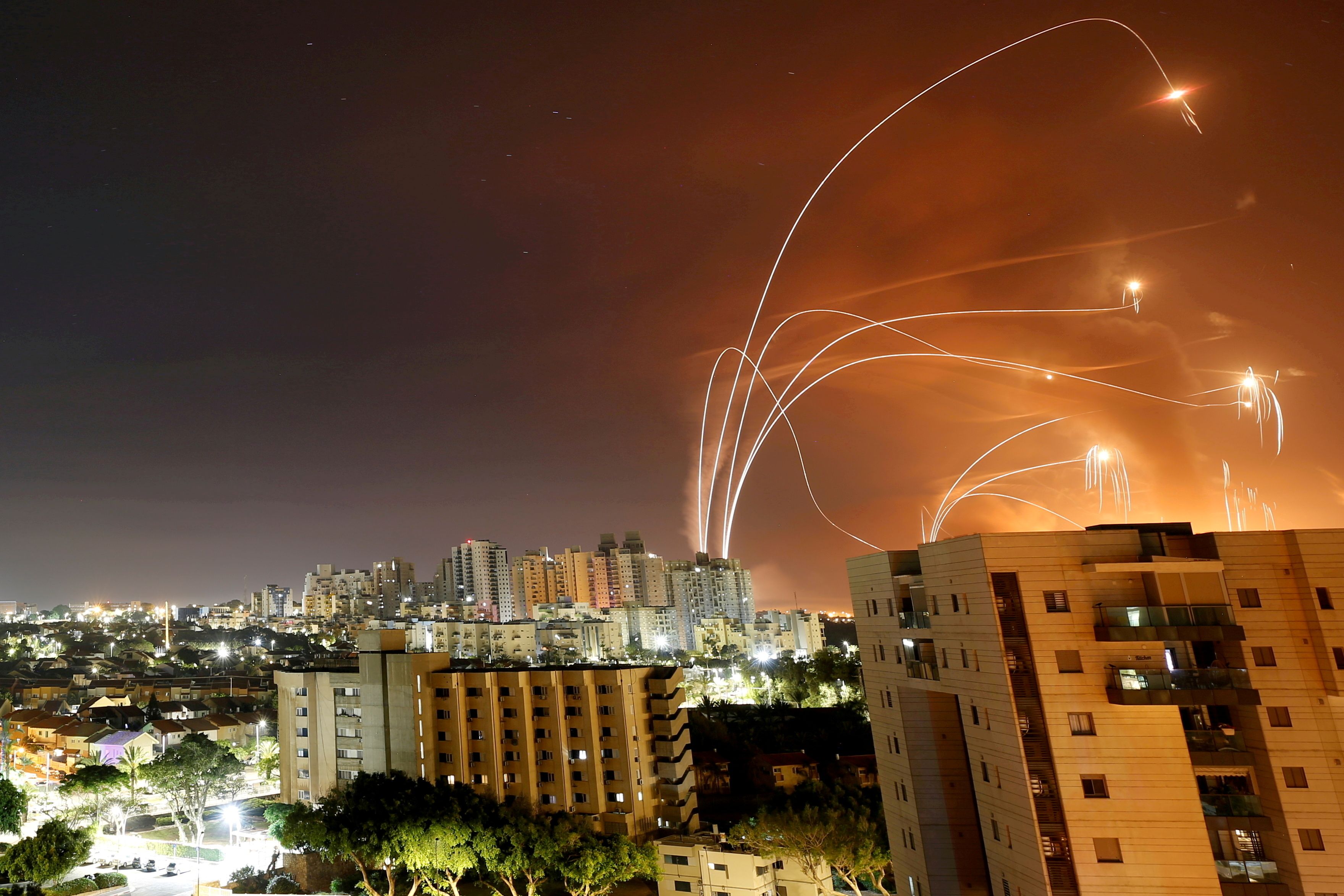 Streaks of light are seen as Israel's Iron Dome anti-missile system intercepts rockets launched from the Gaza Strip towards Israel, as seen from Ashkelon, Israel, May 12 2021.