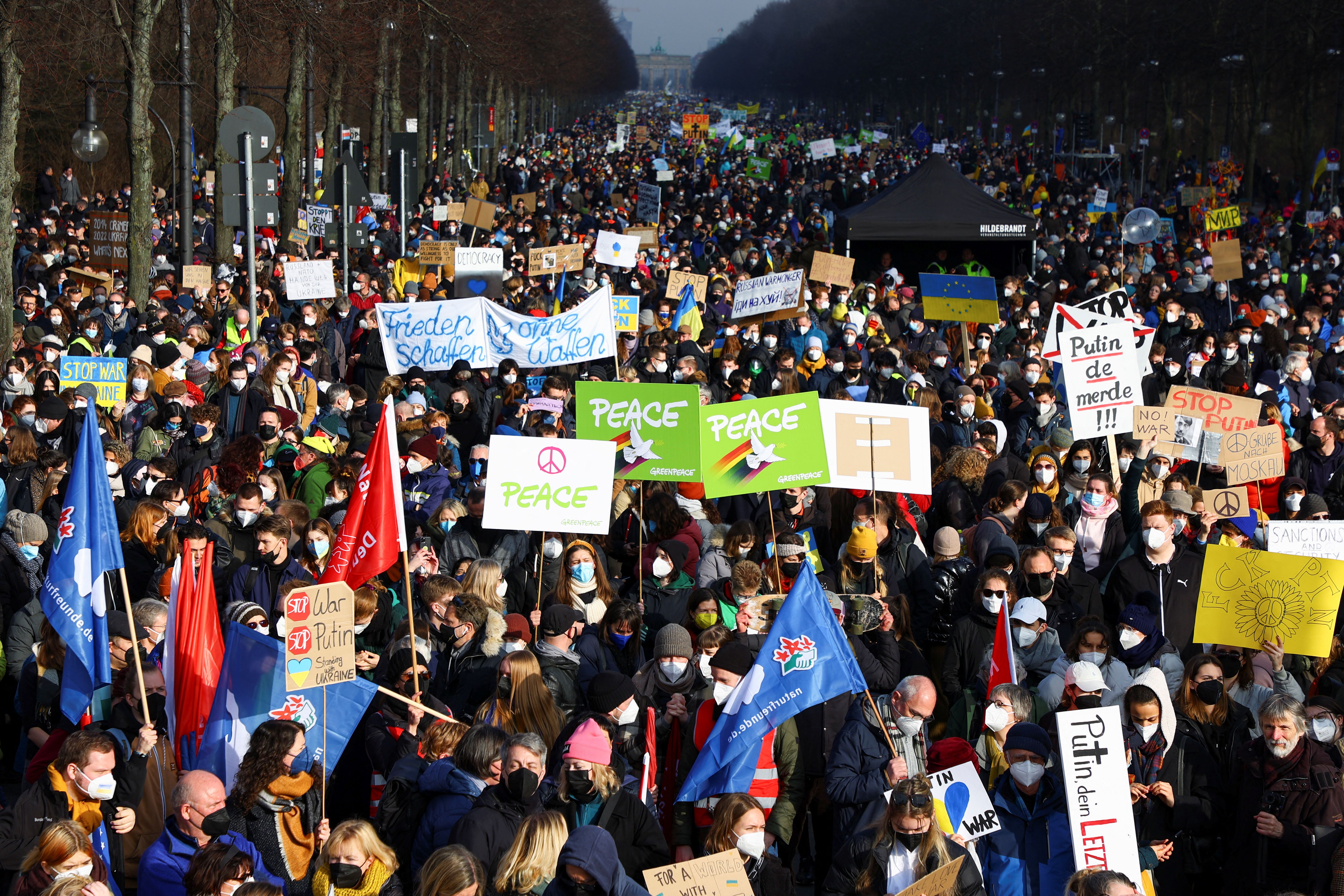Demonstrators carry flags and placards as they take part in an anti-war protest in Berlin, after Russia invaded Ukraine. February 27, 2022.