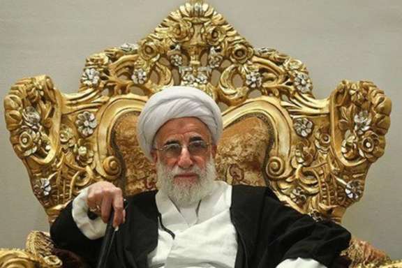 Ahmad Jannati, 96, sitting in an oppulant chair. Undated