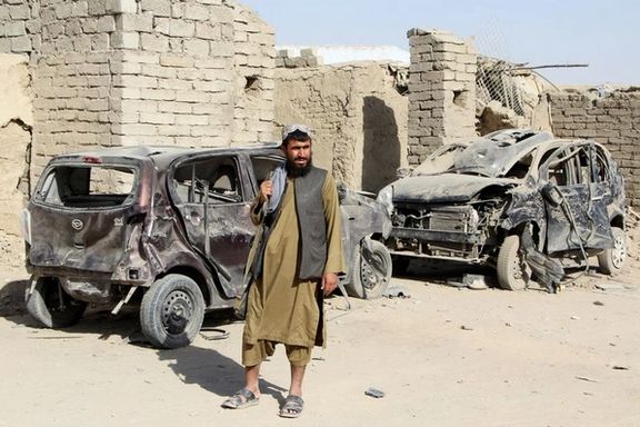 یک جنگجوی طالبان کنار خودروهای منهدمشده در پی حمله هوایی، پس از آتشبس موقت در میانه درگیری افغانستان و پاکستان، در اسپینبولدک