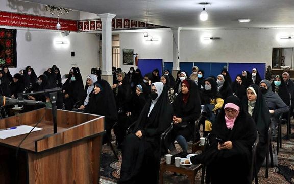 A group wedding of Afghans in Iran. Women sit separate from the men.