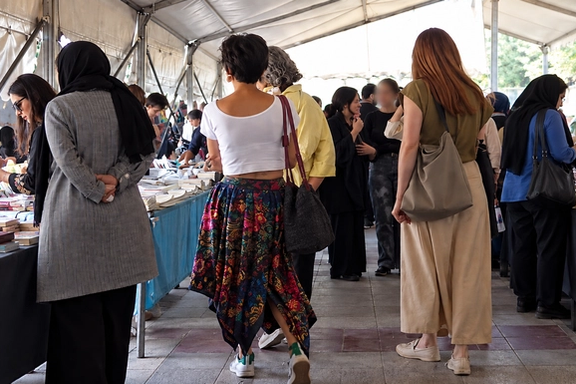 People walk and shop in a local market in Tehran, Iran, summer of 2026