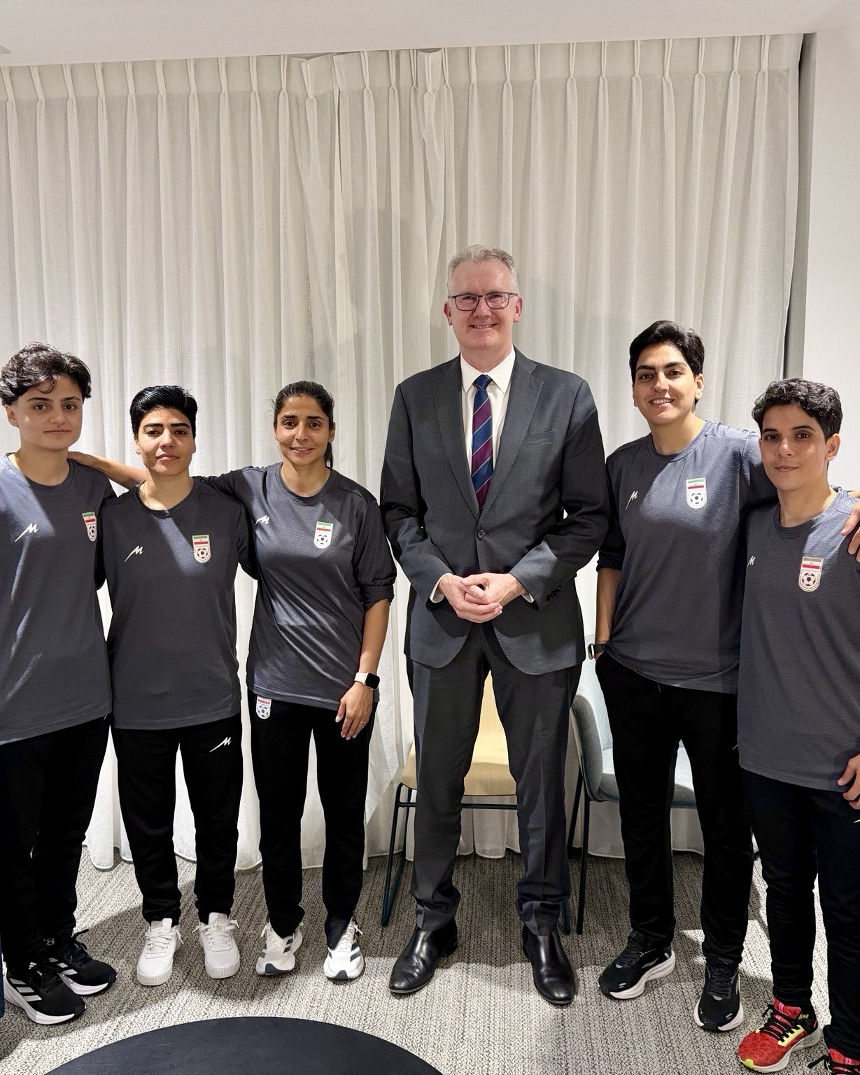 Australia’s Minister for Home Affairs, Tony Burke in group photo with five members of the Iranian women's football team who sought asylum in Australia.