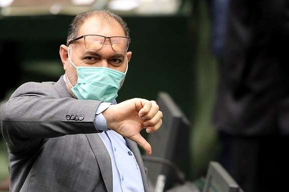 A member of Iran's parliament votes against a bill.