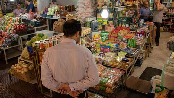 A man looking at the goods at Tehran’s bazaar