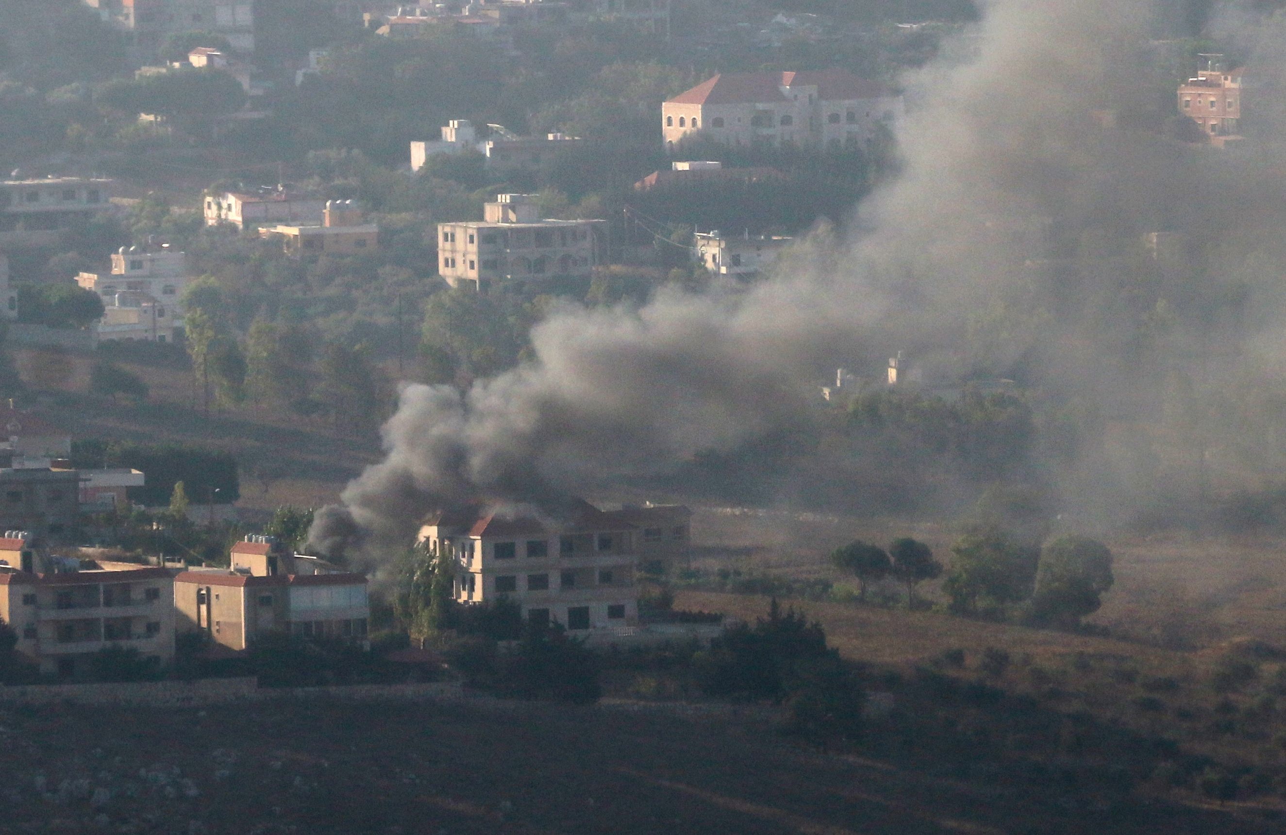Smoke rises from the southern Lebanese town of Khiam, amid ongoing cross-border hostilities between Hezbollah and Israeli forces, as pictured from Marjayoun, near the border with Israel, August 25, 2024. 