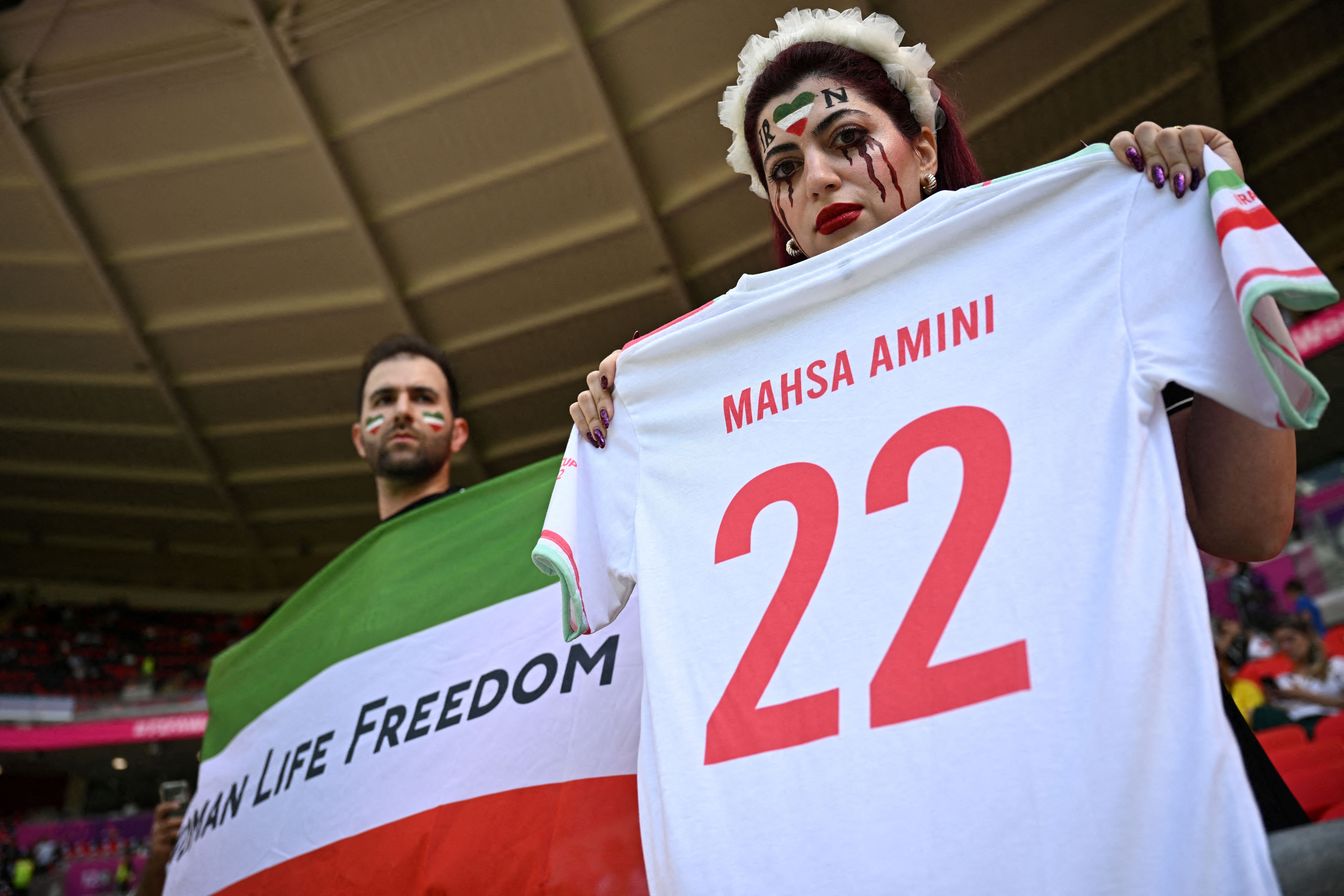Iranian fans displaying messages in support of women and freedom during Iran's match against Waled on November 25, 2022