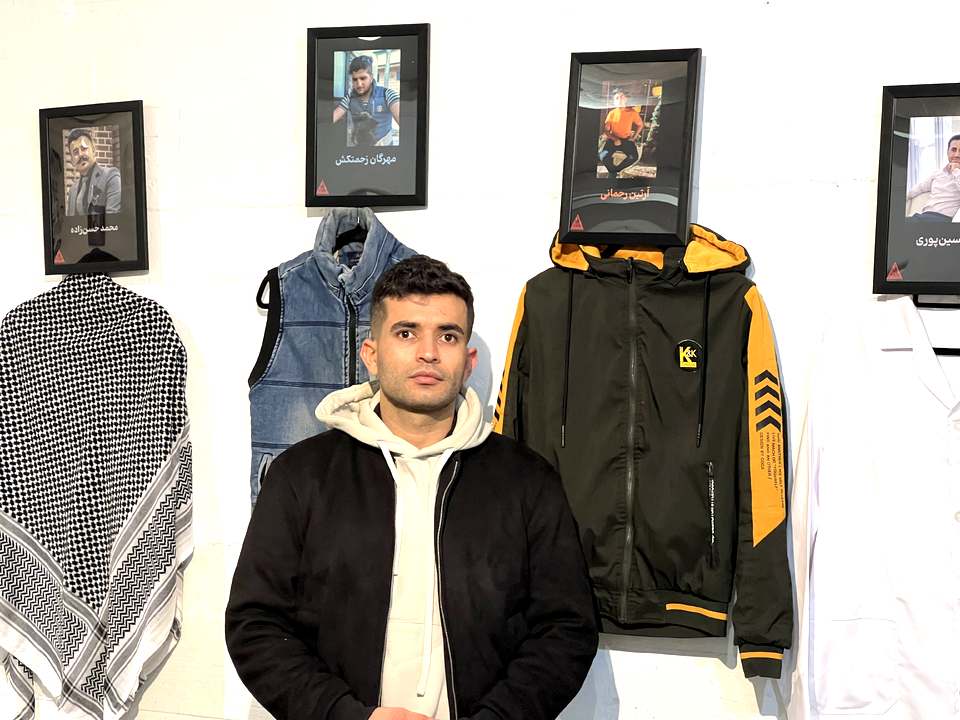 Slain teen protestor, Artin Rahmani's uncle standing next to Artin's jacket 