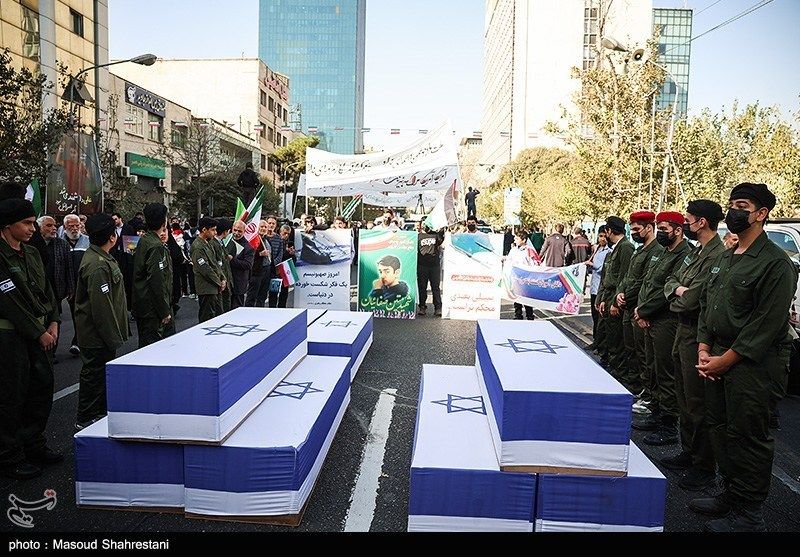 Symbolic coffins draped in Israeli flags are carried during a rally in Tehran marking the anniversary of the 1979 US embassy takeover (November 4, 2025) 