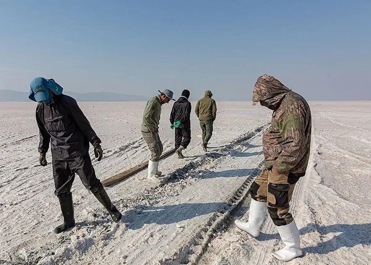 People walk across the dried basin of Lake Urmia.