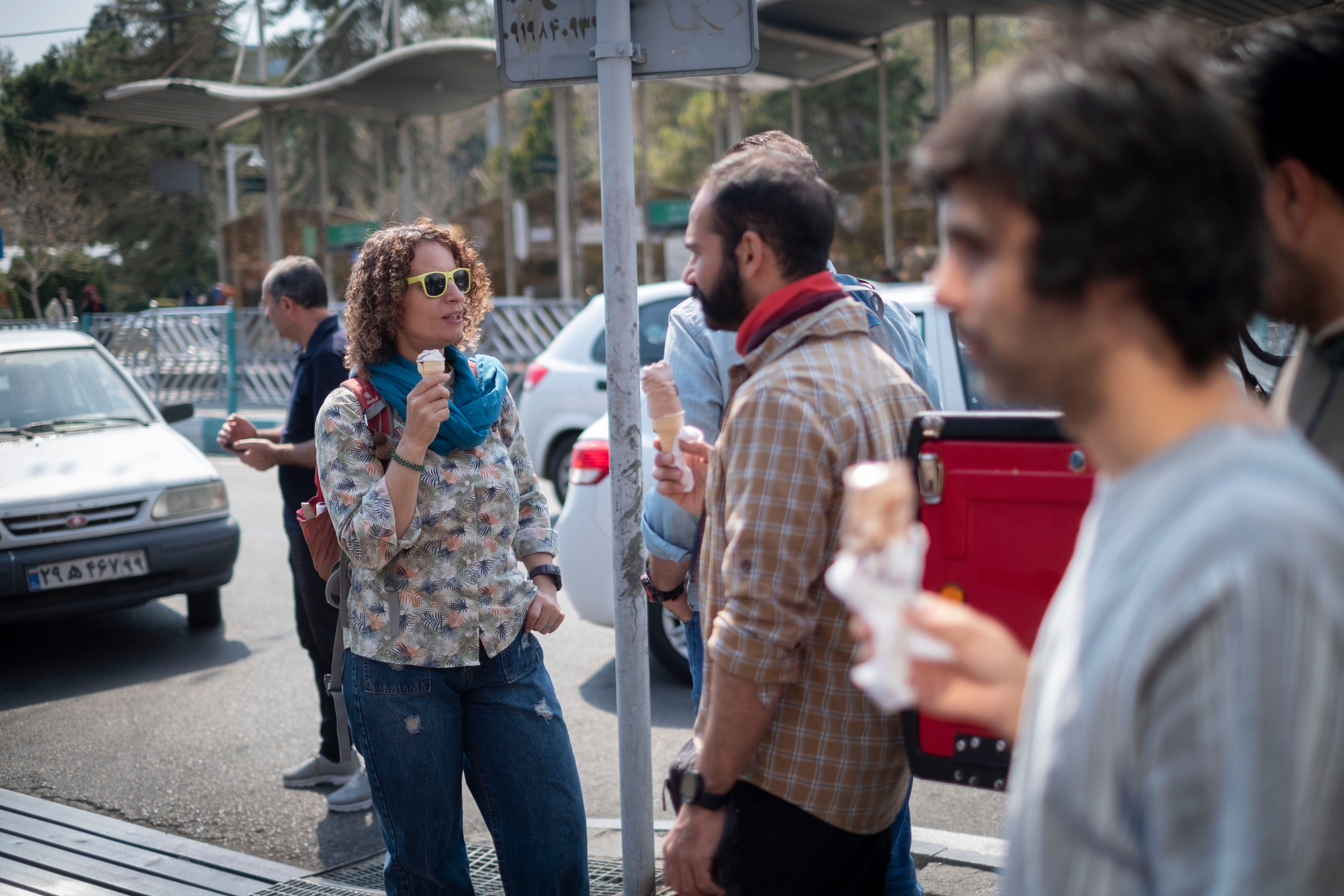 Iranian youths are eating ice cream while they are standing together outside a park during the Sizdah Bedar, also known as Nature's Day, in the fasting month of Ramadan in northern Tehran, Iran April 1, 2024. 