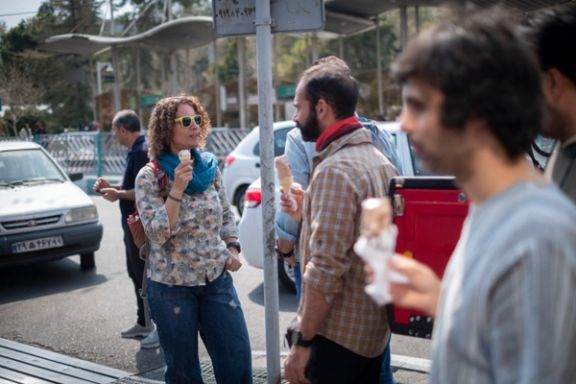 Iranian youths are eating ice cream while they are standing together outside a park during the Sizdah Bedar, also known as Nature's Day, in the fasting month of Ramadan in northern Tehran, Iran April 1, 2024.