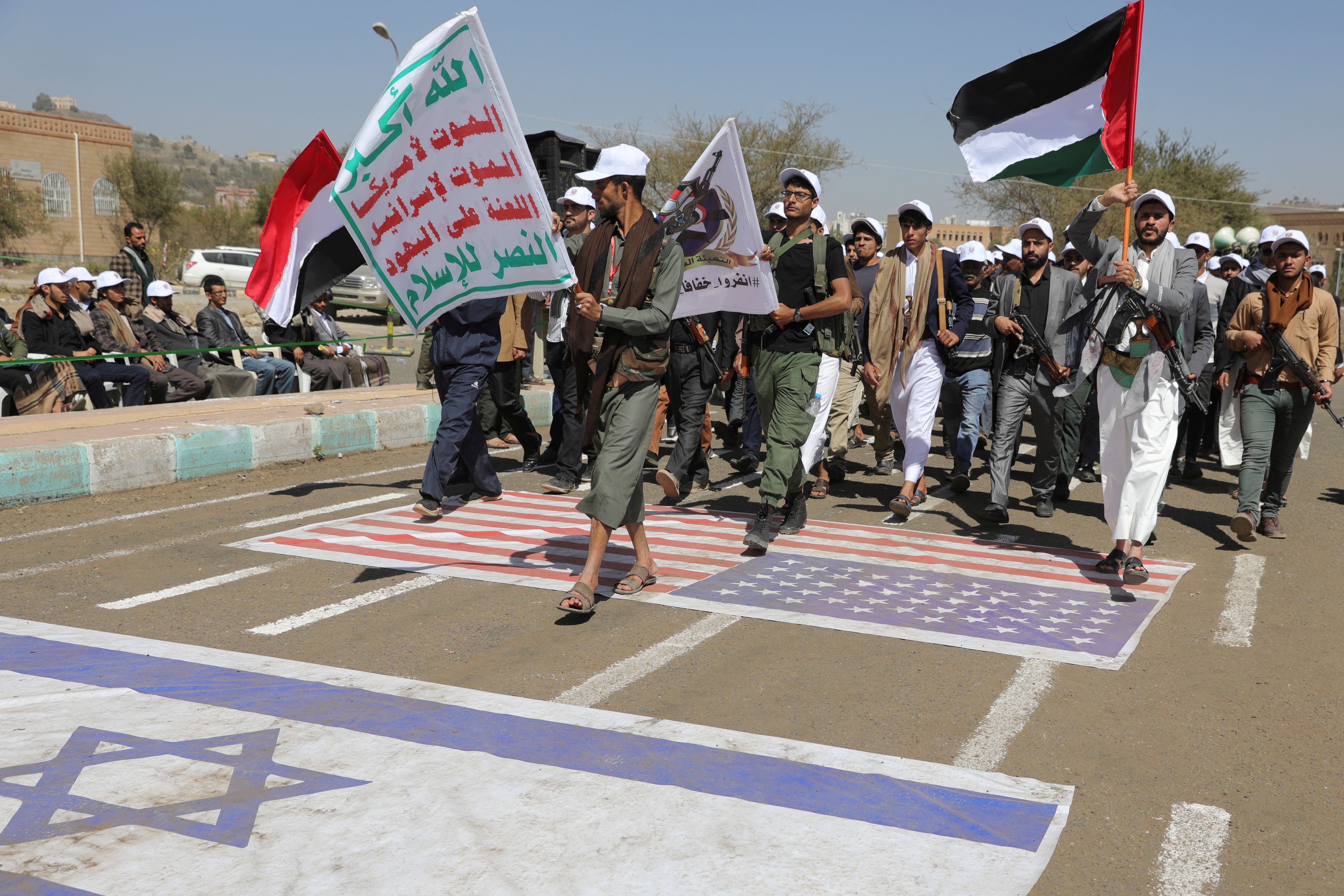 University students march during a parade by students recruited to the ranks of the Houthis as part of a mobilization campaign they have initiated recently, at the campus of Sanaa University in Sanaa, Yemen February 21, 2024.