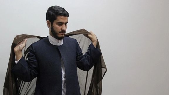 A young cleric putting on the right attire.