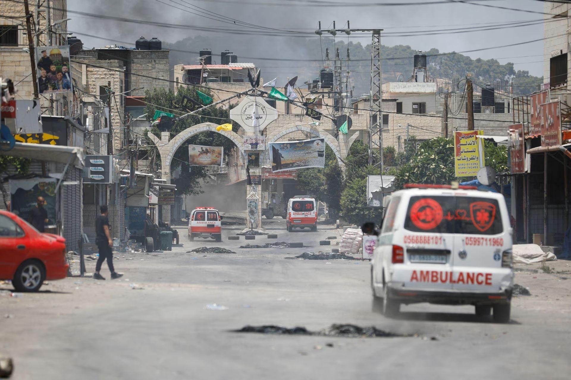 Smoke rises as ambulances drive during an Israeli military operation in Jenin, in the West Bank July 3, 2023.