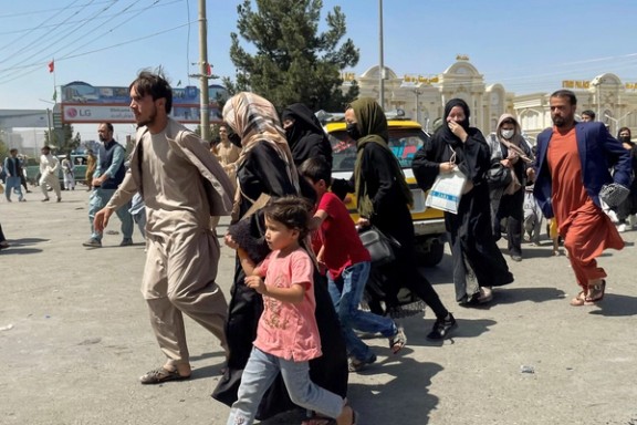 People try to get into Hamid Karzai International Airport in Kabul, Afghanistan, August 16, 2021.