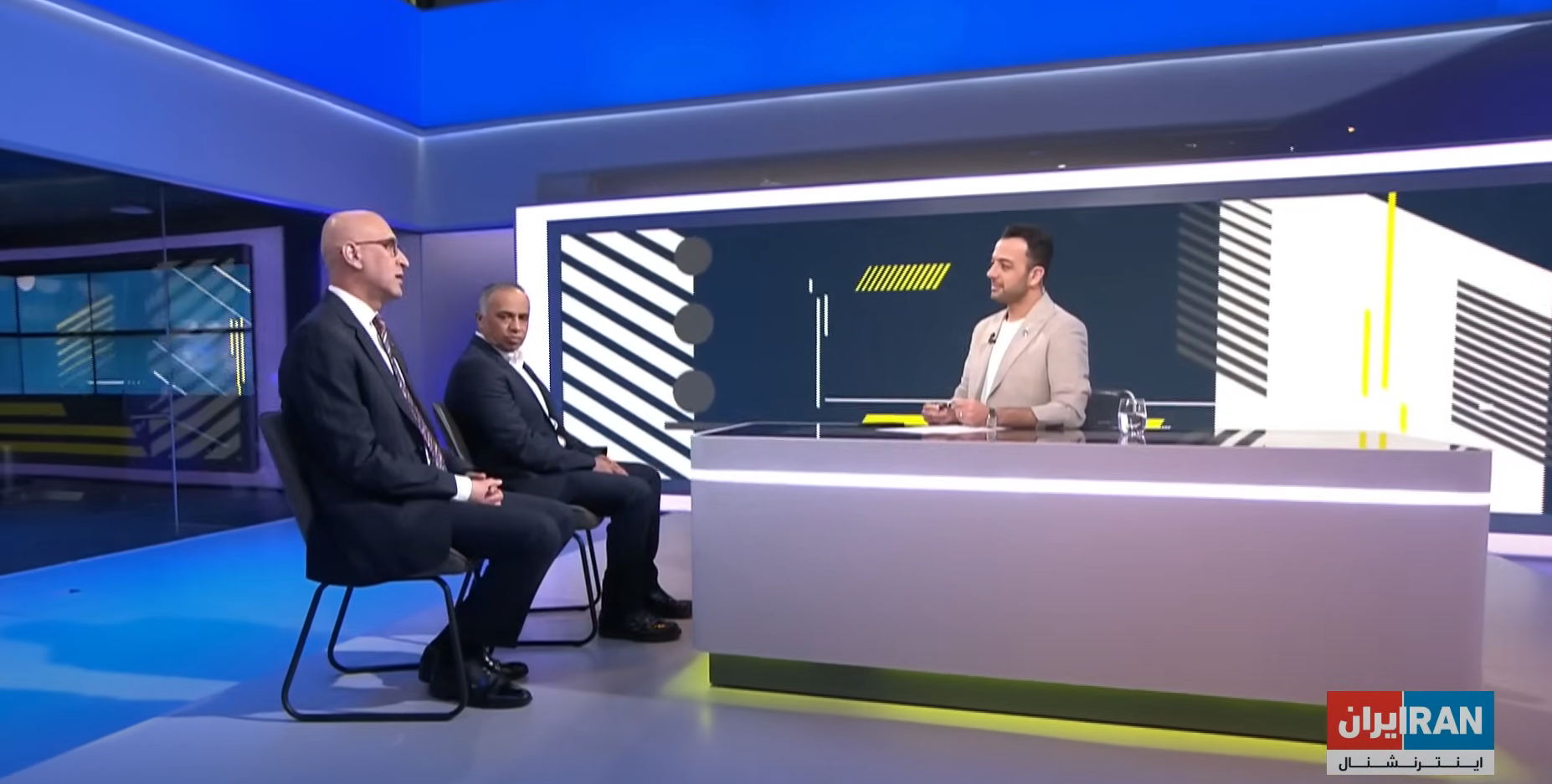 Iran International television directors Mehdi Parpanchi (L) and Aliasghar Ramezanpour with Pouria Zeraati during his TV show on April 5, 2024