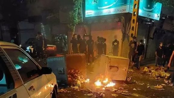 Young protesters, all in black to make identification by police difficult, on a Tehran street in October