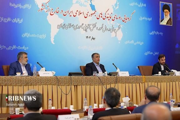 The head and the spokesman of the Atomic Energy Organization of Iran (AEOI), Mohammad Eslami (center) and Behrouz Kamalvandi (left), speak at a gathering of the heads of Iranian diplomatic missions held at the Foreign Ministry in Tehran in May 2023.