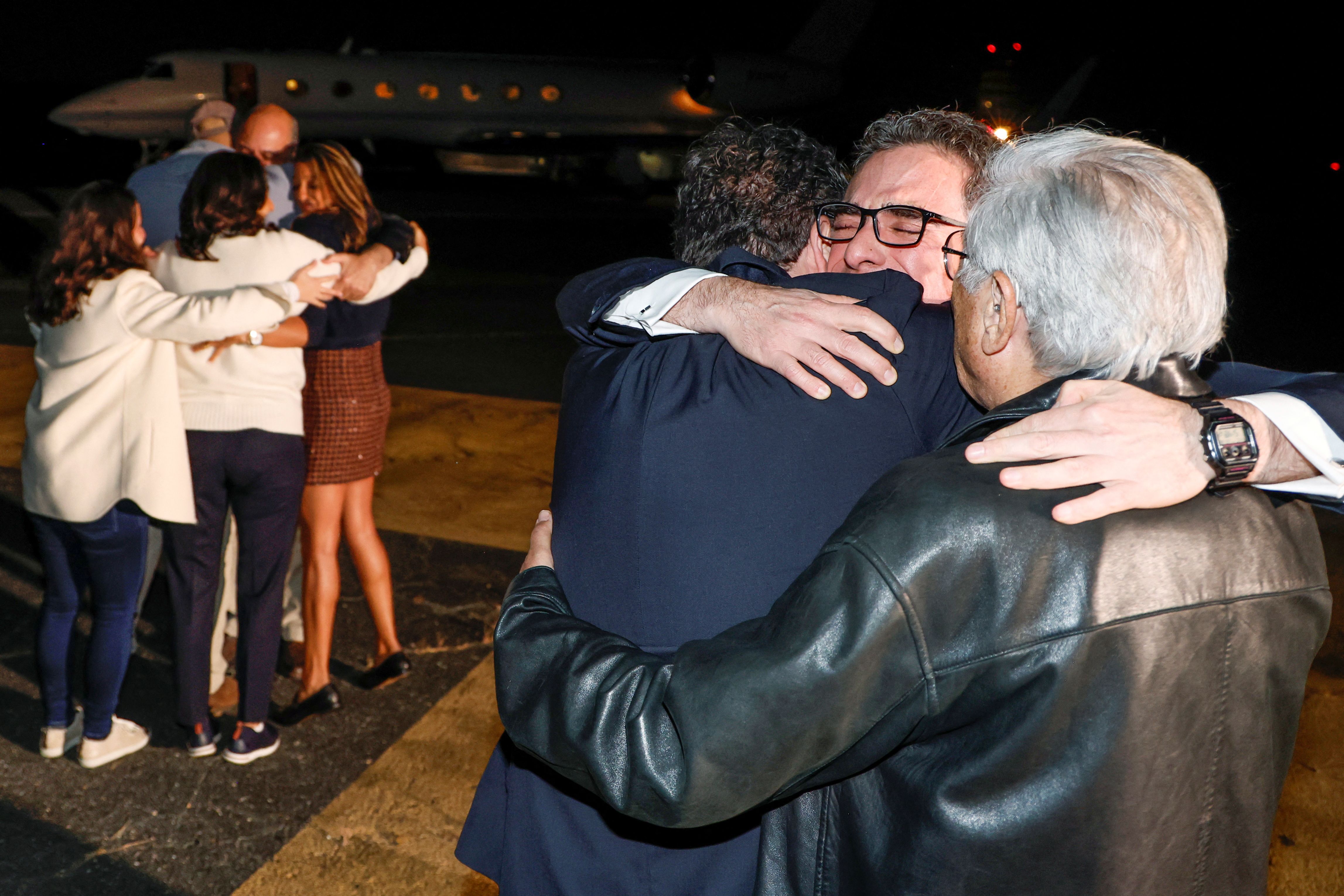 Family members embrace freed Americans Siamak Namazi, Morad Tahbaz and Emad Shargi — as well as two returnees whose names have not yet been released arrive at Davison Army Airfield at Fort Belvoir, Virginia, September 19, 2023. 