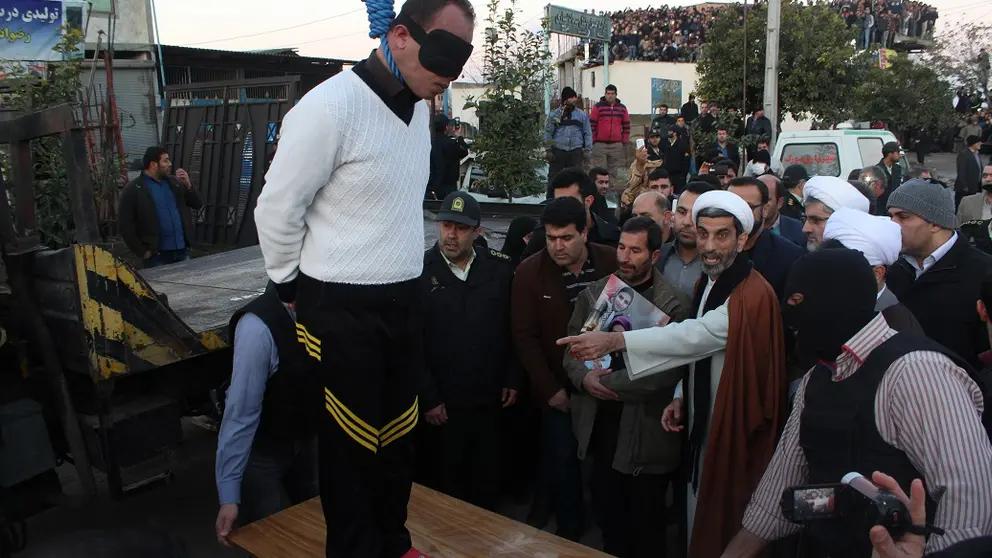A blindfolded man stands on a platform moments before his public execution in Iran (Undated)