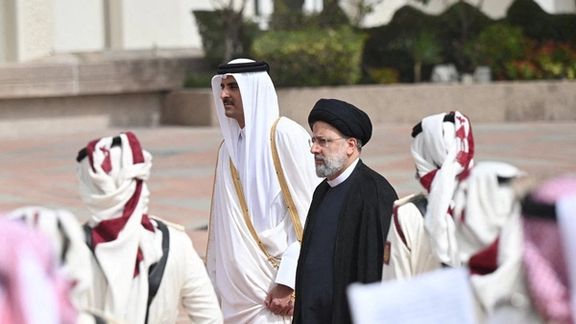 Qatar's Emir Sheikh Tamim bin Hamad Al-Thani and Iran's President Ebrahim Raisi walk during a welcome ceremony in Doha, Qatar, February 21, 2022.