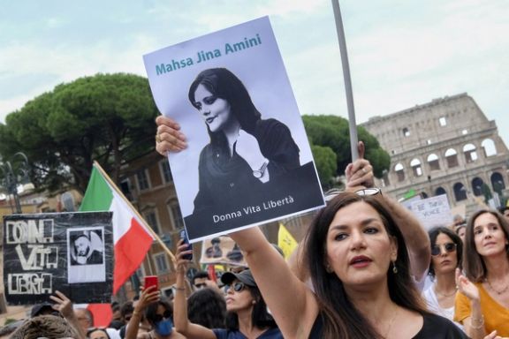 An Iranian protester holding a photo of Mahsa Amini during an anti-regime rally in Rome