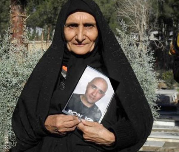 Gohar Eshgi with the photo of her dead son Sattar Beheshti. Undated