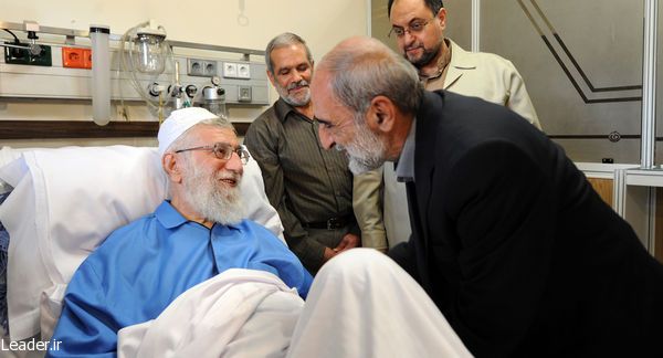 Hossein Shariatmadari, the hardline editor of the Kayhan newspaper, visiting Supreme Leader Ali Khamenei (left) at hospital in 2014  
