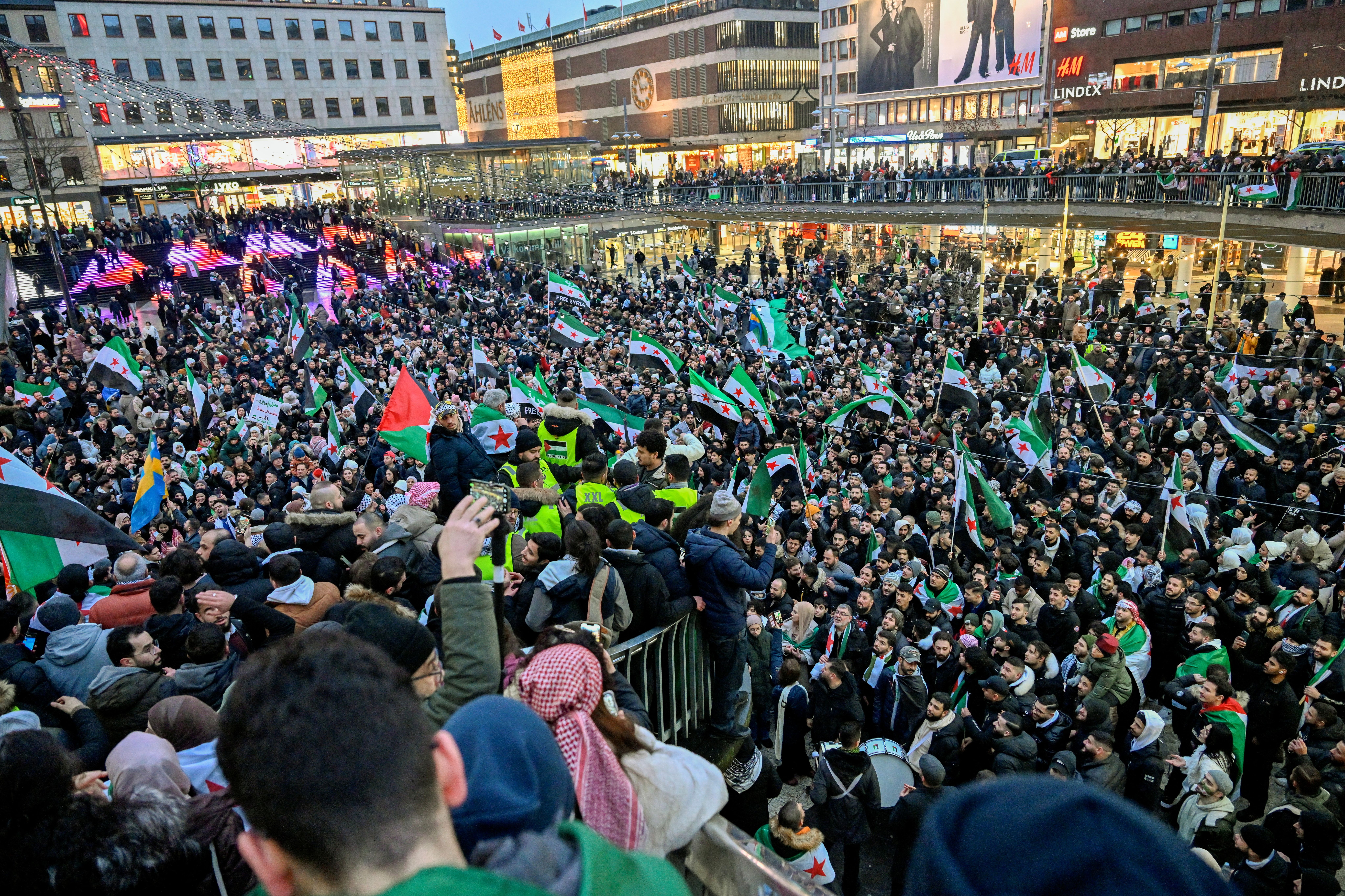 Syrians celebrate, after Syrian rebels announced that they have ousted Syria's Bashar al-Assad, during a demonstration in Sergel's Square in Stockholm, Sweden December 8, 2024. 