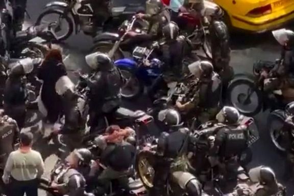 Special police units on motorcycles assaulting a woman in Tehran on Oct. 23, 2022