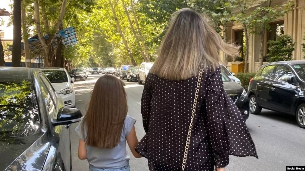 An Iranian woman and her daughter without mandatory hijab on the streets of capital Tehran  