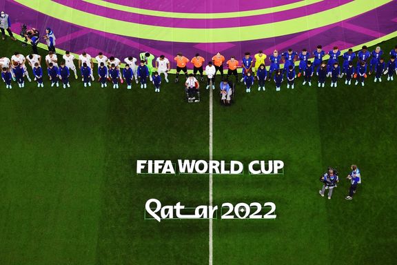 Iranian and US teams and match officials line up before their World Cup match at Doha’s Al Thumama Stadium, Qatar, on November 29, 2022
