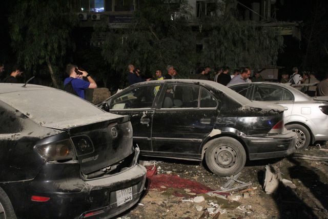 People inspect the site of an Israeli airstrike that targeted a residential building in the Mezzah suburb west of the Syrian capital Damascus, Syria's state news agency reported, Syria October 8, 2024.