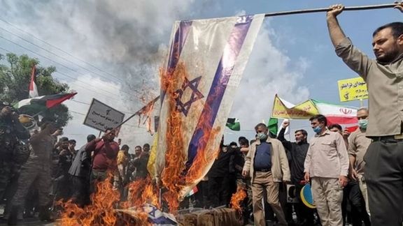 Quds Day crowd in the ritual of burning an Israeli flag in 2022