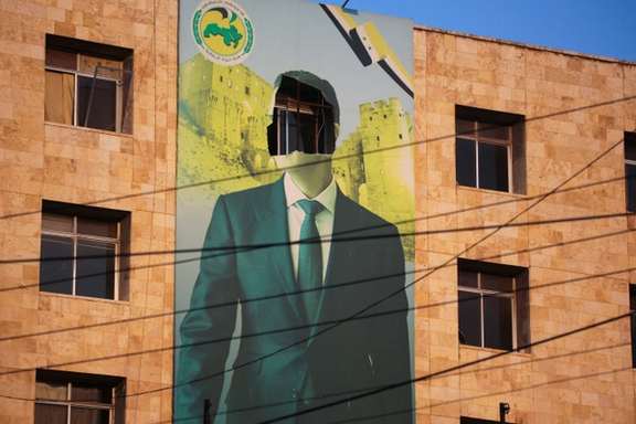 A view shows a damaged poster of Syria's President Bashar al-Assad in Aleppo, after the Syrian army said that dozens of its soldiers had been killed in a major attack by rebels who swept into the city, in Syria November 30, 2024.