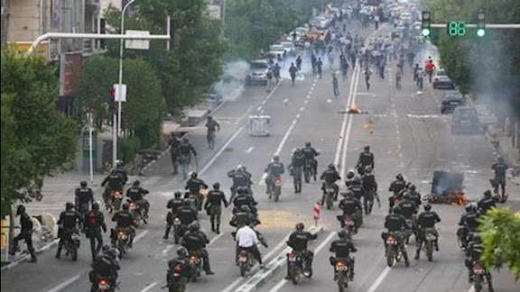 Riot police against protesters in Tehran during 2019 protests