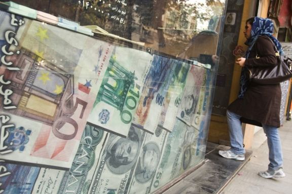 A woman enters a currency exchange shop in Tehran's business district October 24, 2011.