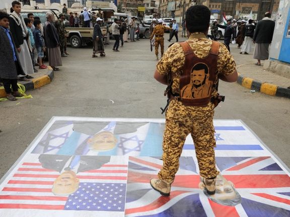 A Houthi policeman stands on a banner with pictures of Israeli Prime Minister Benjamin Netanyahu, British Prime Minister Rishi Sunak and US President Joe Biden during a parade by Houthi recruits in Sanaa, Yemen, February 8, 2024.