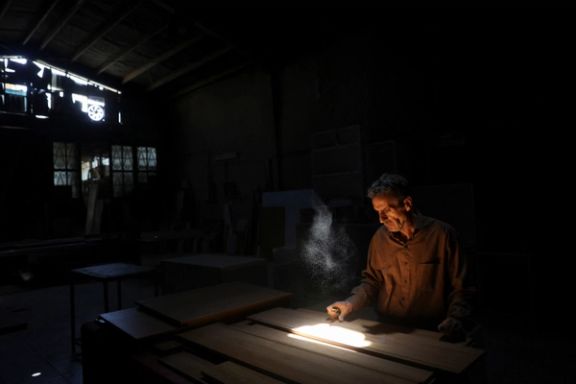 A carpenter works following a power outage at a carpentry workshop in Tehran, Iran, June 1, 2025.