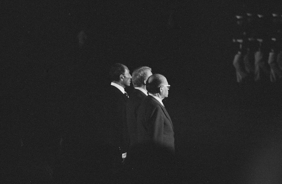 US President Jimmy Carter, Egyptian President Anwar Sadat, and Israeli Prime Minister Menachem Begin review U.S. Marines during the Camp David summit, at Camp David, Maryland, September 6, 1978. 