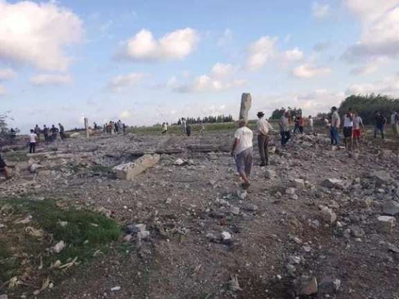 Locals gather at the site of a missile attack in al-Hamidiyah area near Syria’s western port Syrian city of Tartus on July 2, 2022