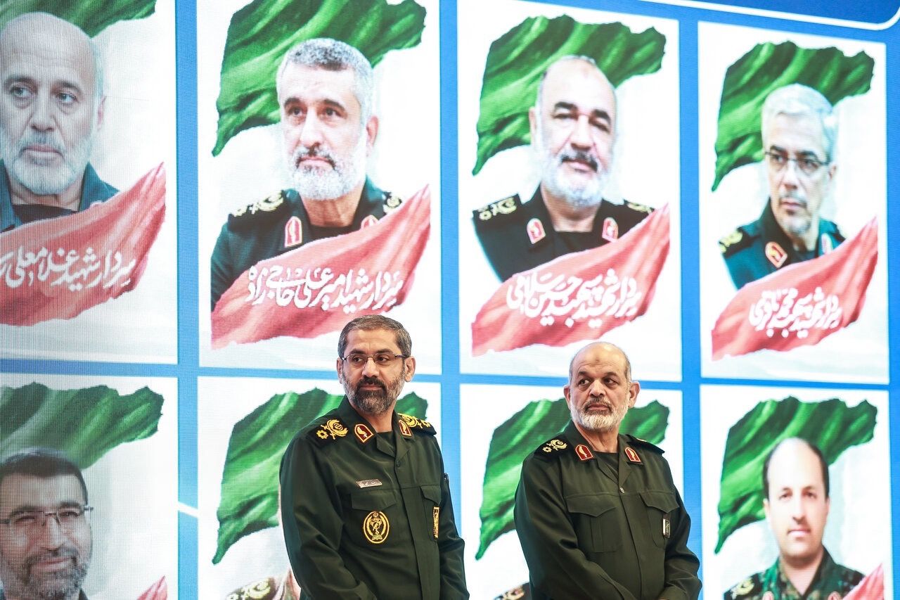 IRGC commanders Ahmad Vahidi (right) and Reza Sahaban stand before portraits of slain commanders in an event in Tehran, January 25, 2026
