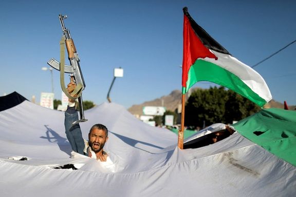 A protester holds a gun, as he takes part in a demonstration in solidarity with Palestinians in the Gaza Strip, amid the ongoing conflict between Israel and the Palestinian Islamist group Hamas, in Sanaa, Yemen December 8, 2023.